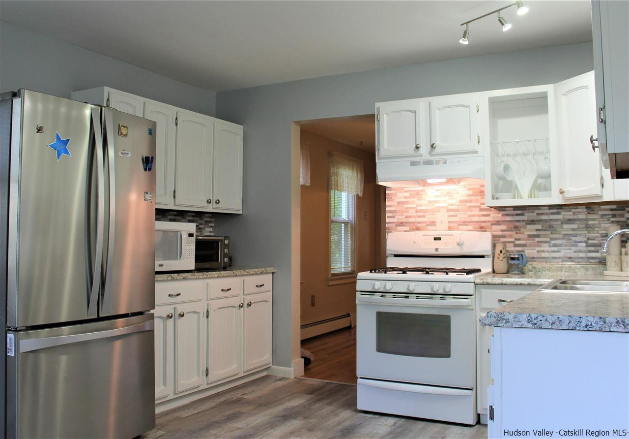 170 Samsonville Road Kerhonkson, NY 12446 - Photo 12 of 35 a kitchen with cabinets stainless steel appliances and wooden floor
