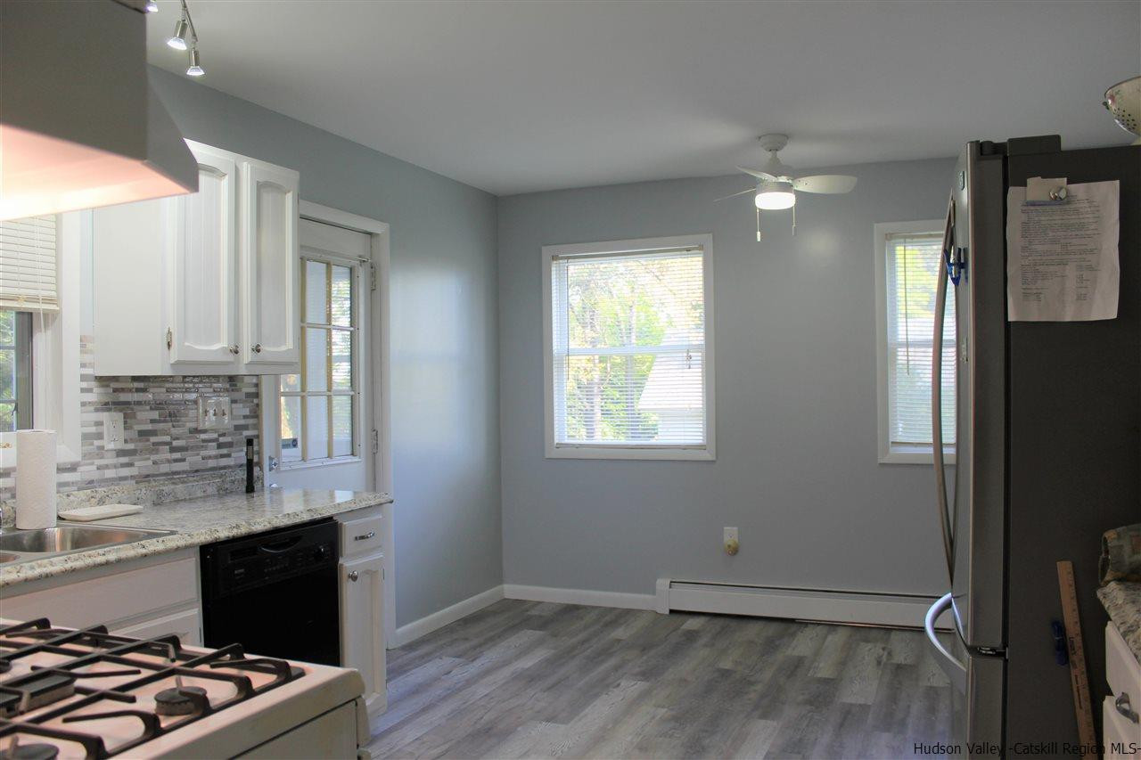 170 Samsonville Road Kerhonkson, NY 12446 - Photo 13 of 35 an empty room with wooden floor cabinet and windows