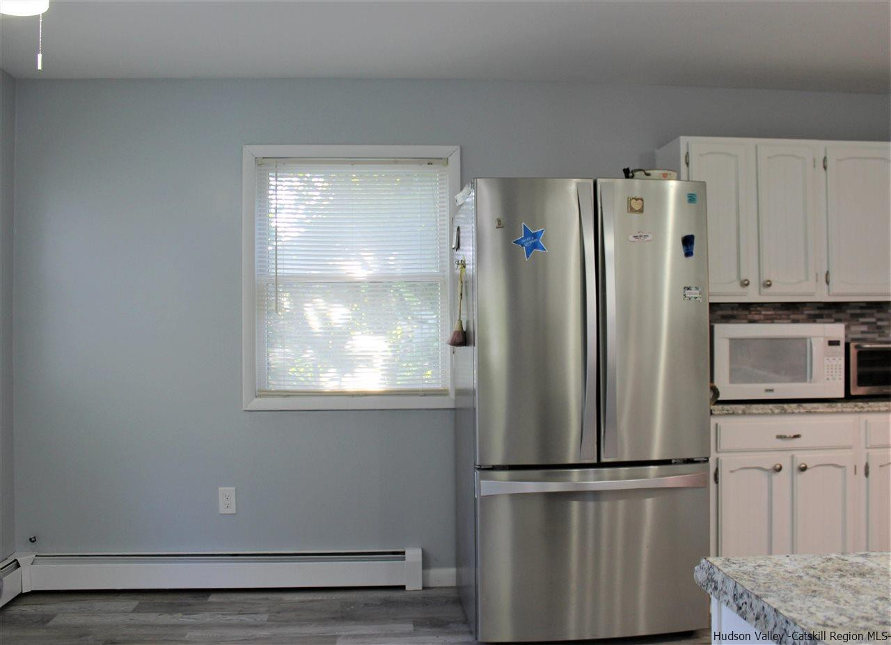 170 Samsonville Road Kerhonkson, NY 12446 - Photo 14 of 35 a white refrigerator freezer and a wooden floor