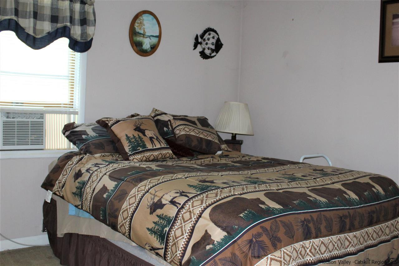 170 Samsonville Road Kerhonkson, NY 12446 - Photo 19 of 35 a bed sitting in a bedroom next to a window and a mirror