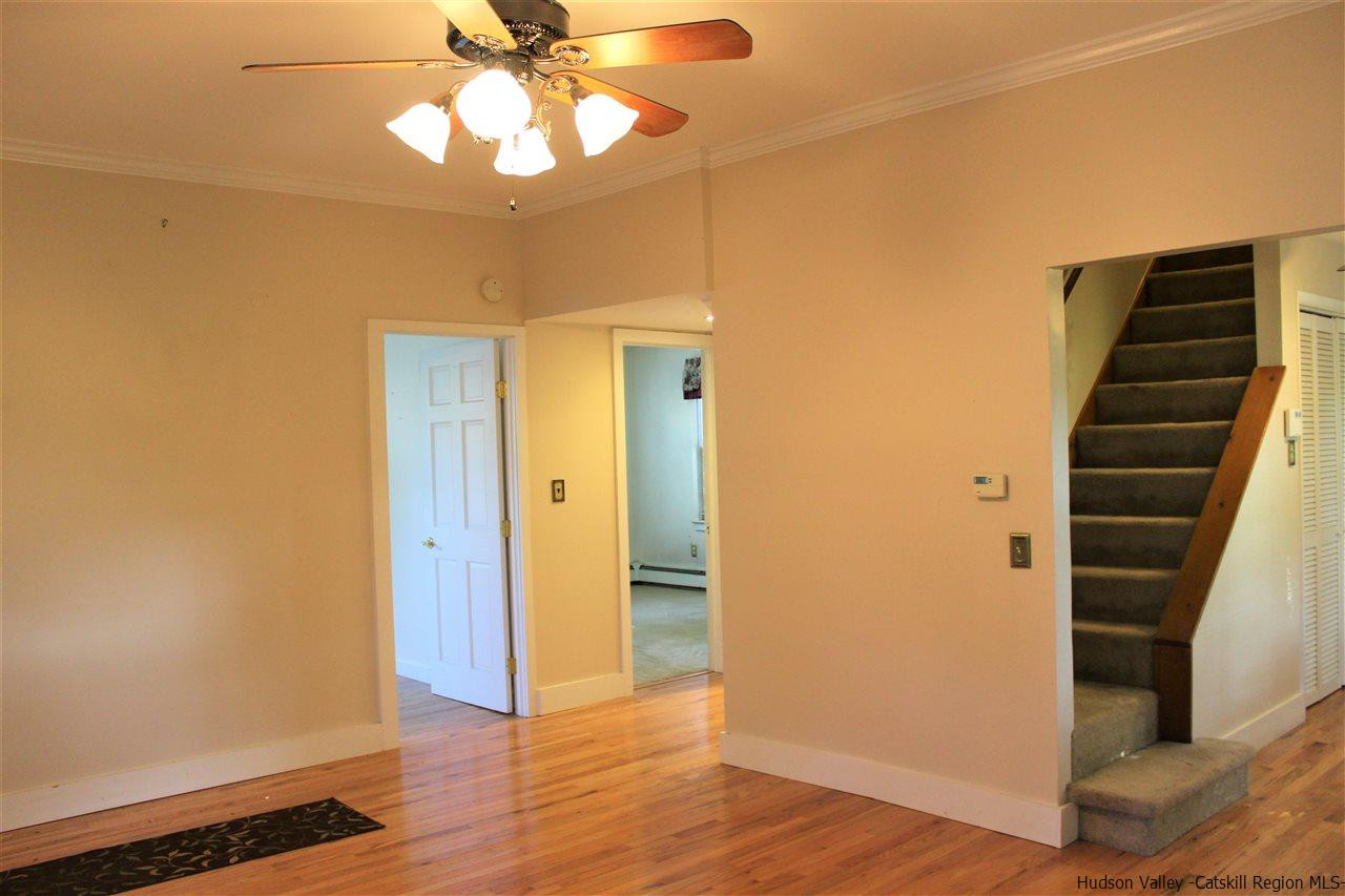 170 Samsonville Road Kerhonkson, NY 12446 - Photo 7 of 35 a view of an empty room with wooden floor and stairs