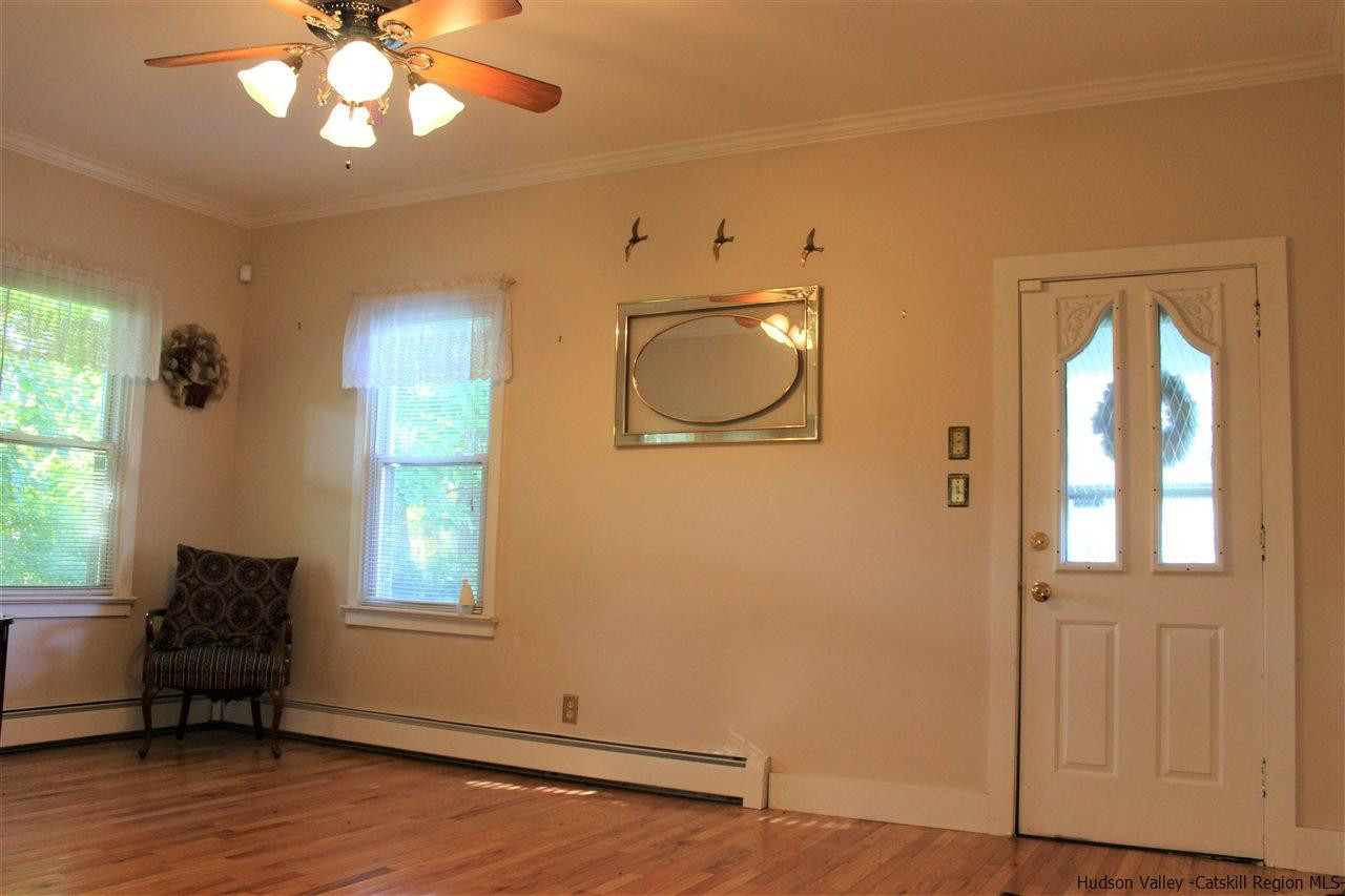 170 Samsonville Road Kerhonkson, NY 12446 - Photo 8 of 35 a view of a livingroom with furniture window wooden floor and a ceiling fan