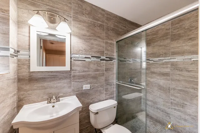 a bathroom with a toilet sink and shower