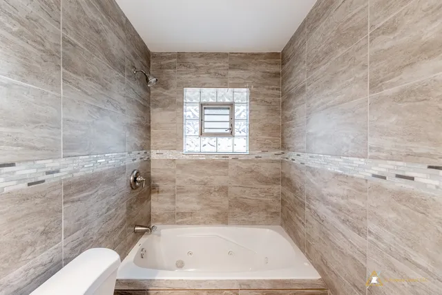 a bath tub sitting in a bathroom next to a window