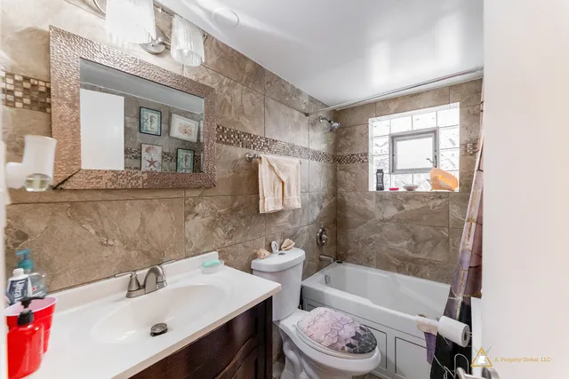 a bathroom with a bathtub a sink and a mirror