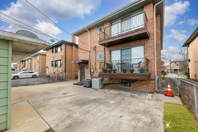 a backyard of a house with barbeque oven table and chairs