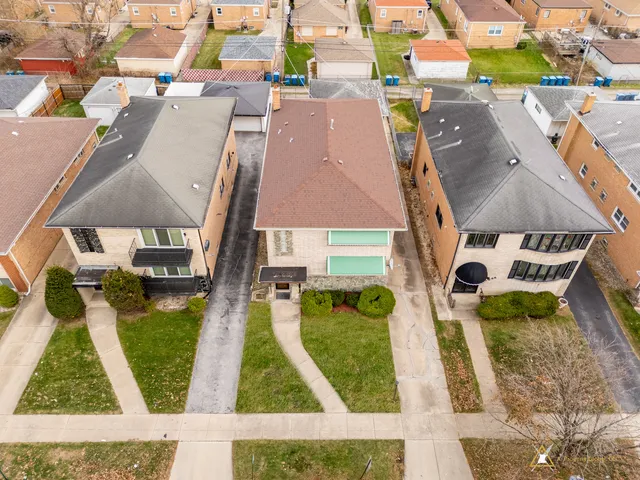 an aerial view of houses with swimming pool