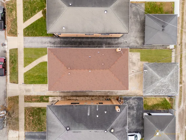 an aerial view of a residential apartment building with a yard
