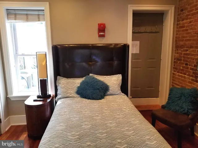 a bedroom with a bed and a window