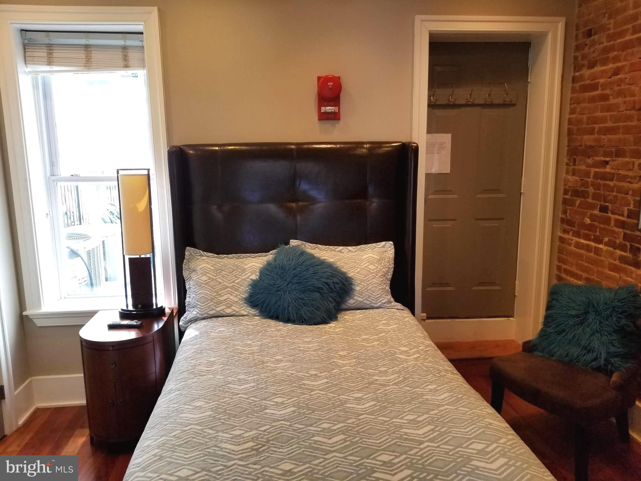 1203 U Street Northwest Washington, DC 20009 - Photo 16 of 40 a bedroom with a bed and a window