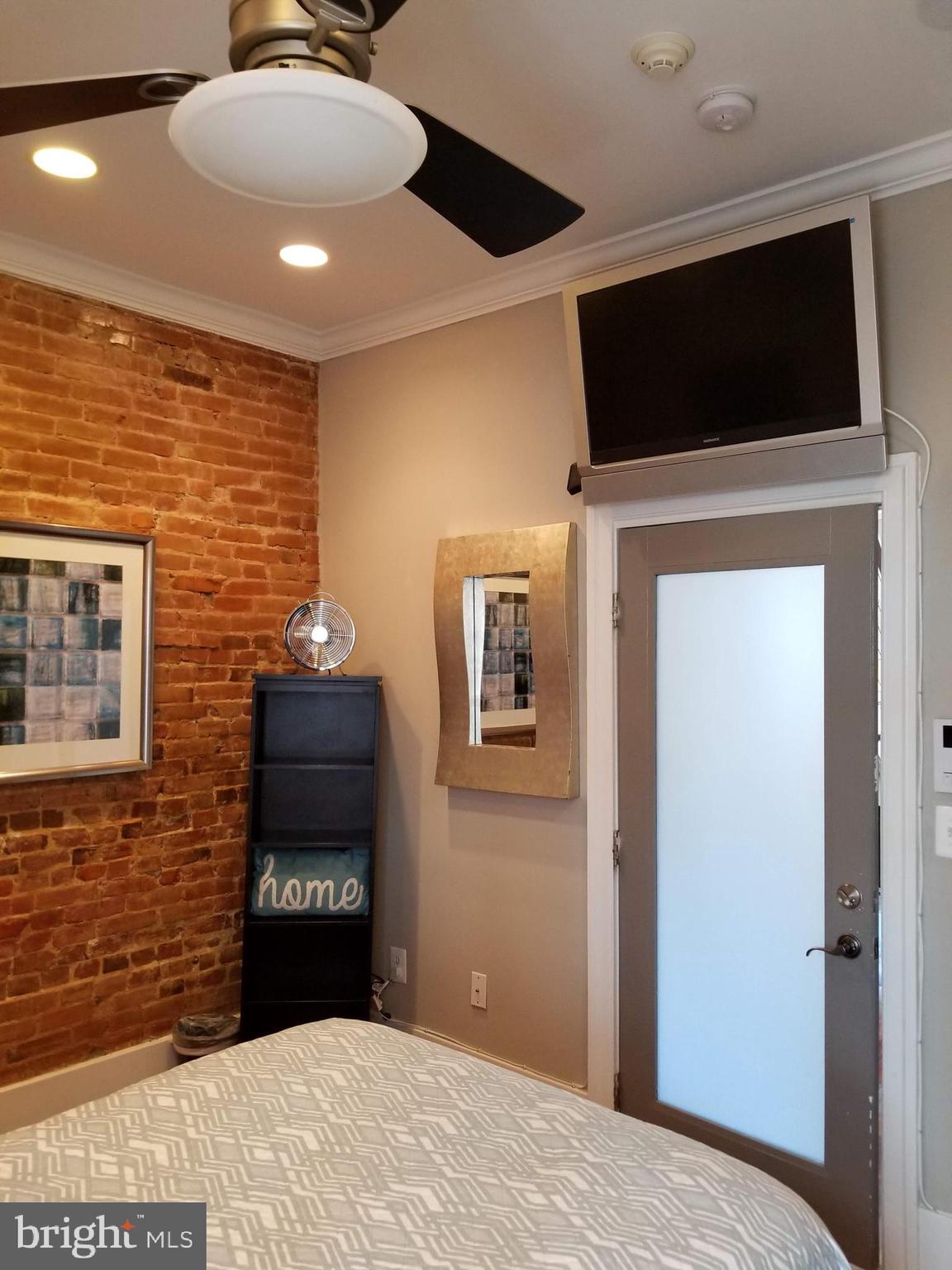 1203 U Street Northwest Washington, DC 20009 - Photo 22 of 40 a bedroom with a bed and a flat screen tv