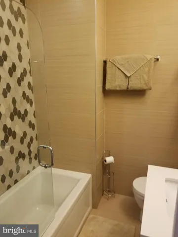 a bathroom with a bathtub and a toilet
