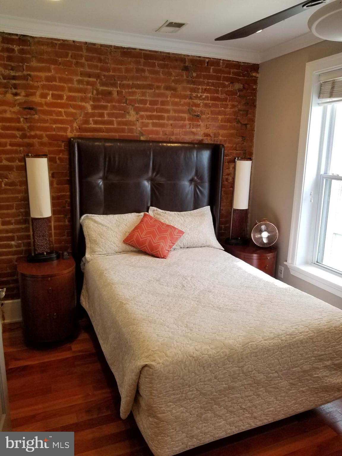 1203 U Street Northwest Washington, DC 20009 - Photo 31 of 40 a bedroom with a bed and a window