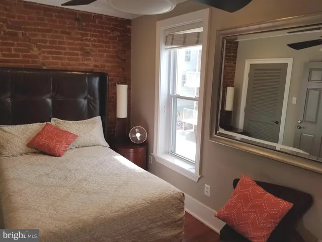 a bedroom with a bed and a window