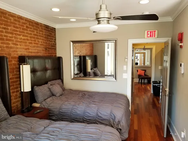 a bedroom with a bed and a mirror