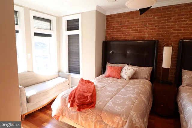 a bedroom with a bed and a fireplace