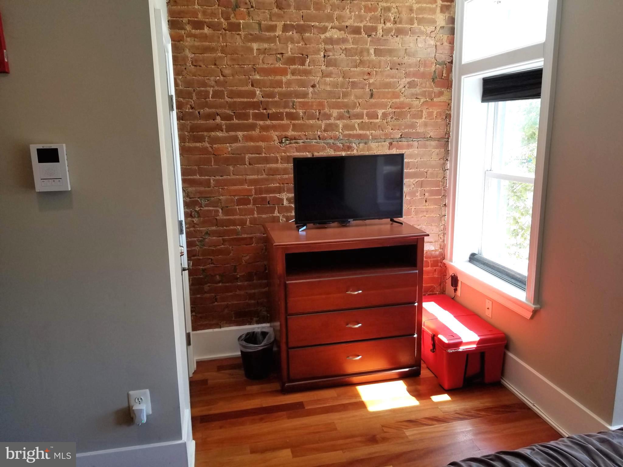 1203 U Street Northwest Washington, DC 20009 - Photo 38 of 40 a room with furniture and flat screen tv