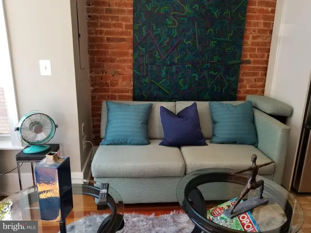 a living room with furniture and a mirror