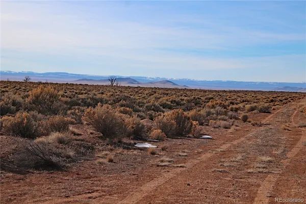 a view of a large mountain with a mountain in the background