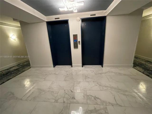 a bedroom with a bed and glass window