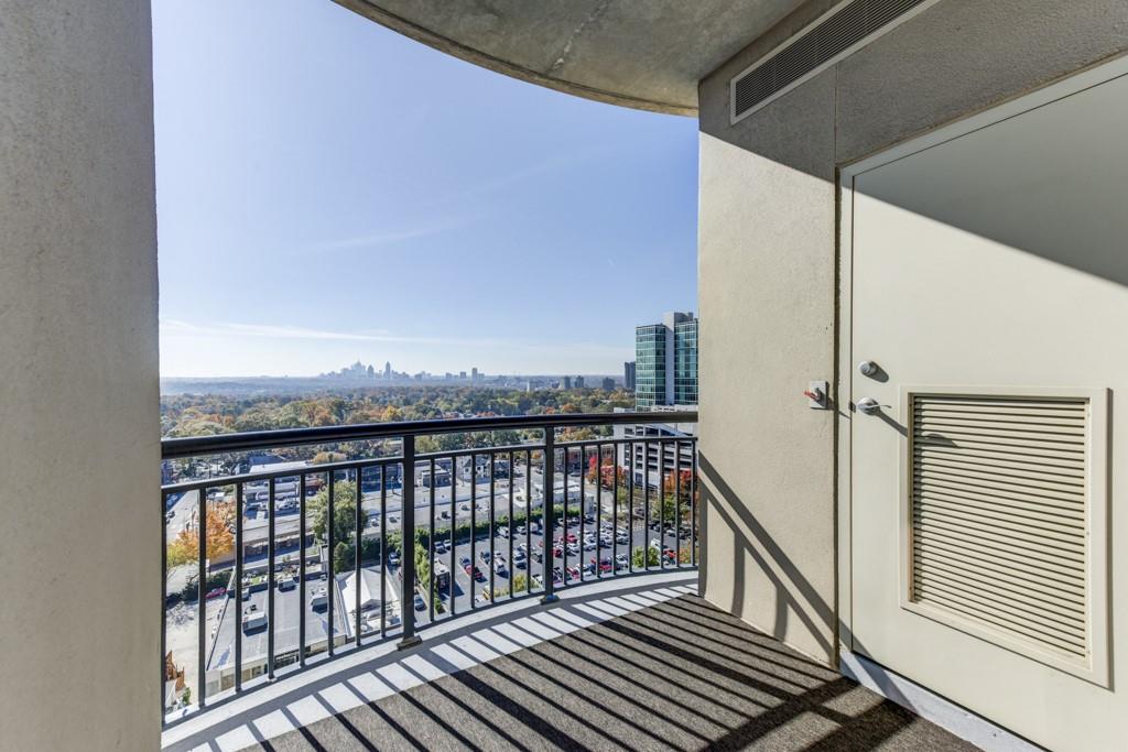 325 East Paces Ferry Road Northeast, Unit 1706 Atlanta, GA 30305 - Photo 12 of 22 a view of a balcony with wooden floor