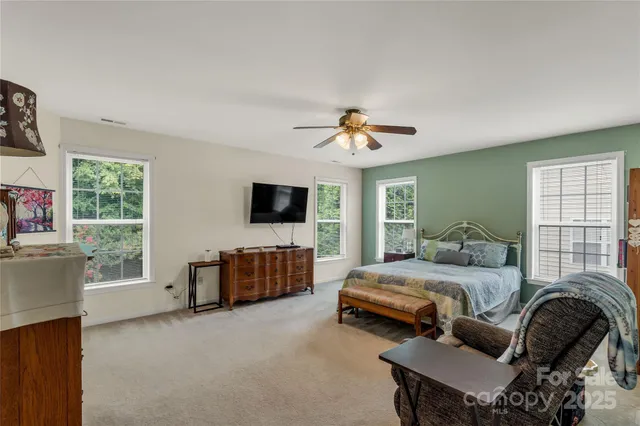 a bedroom with furniture and a flat screen tv