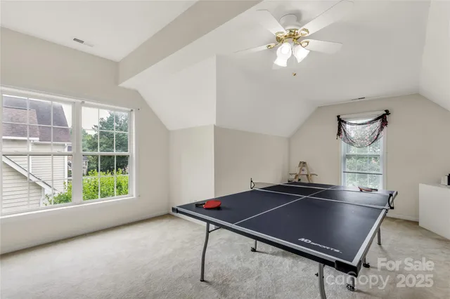 a room with pool table and windows