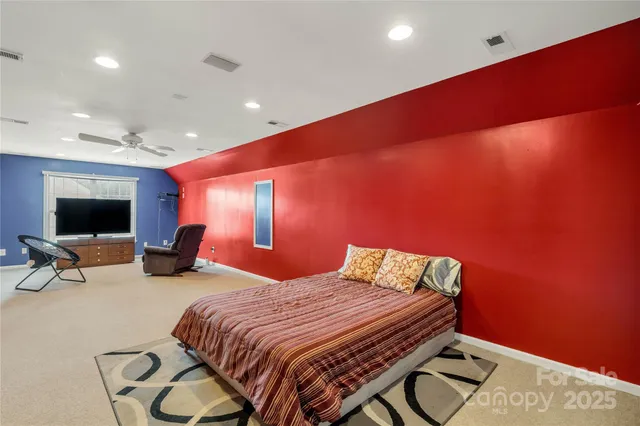 a bedroom with a bed and glass wall