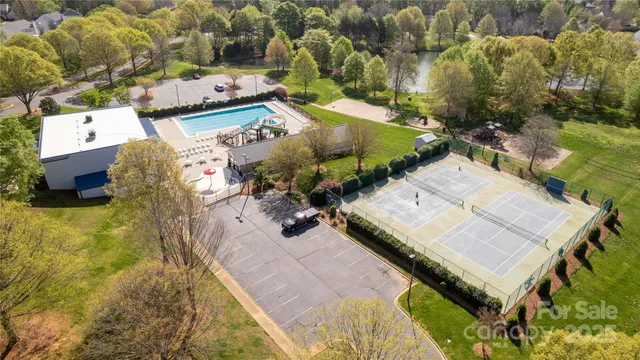 an aerial view of a house with a yard and pool