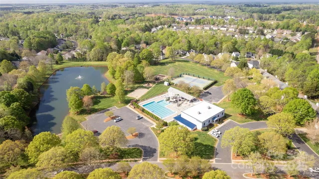 an aerial view of a house with a garden and lake view