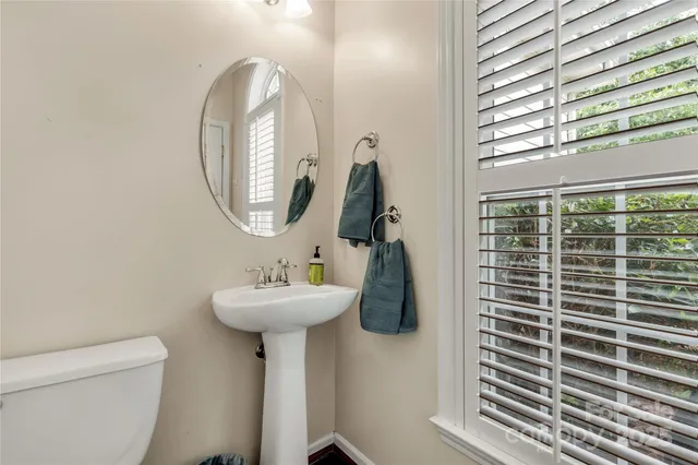 a bathroom with a sink toilet and a mirror