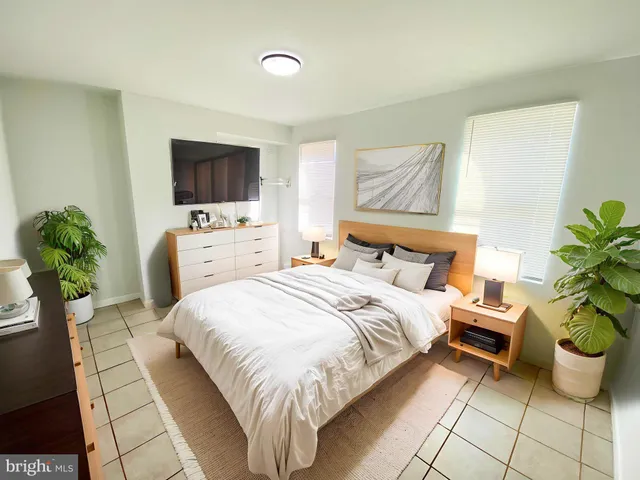 a view of a bedroom with wooden floor and front door