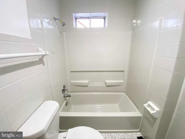 a bedroom with a bed and a wooden floor