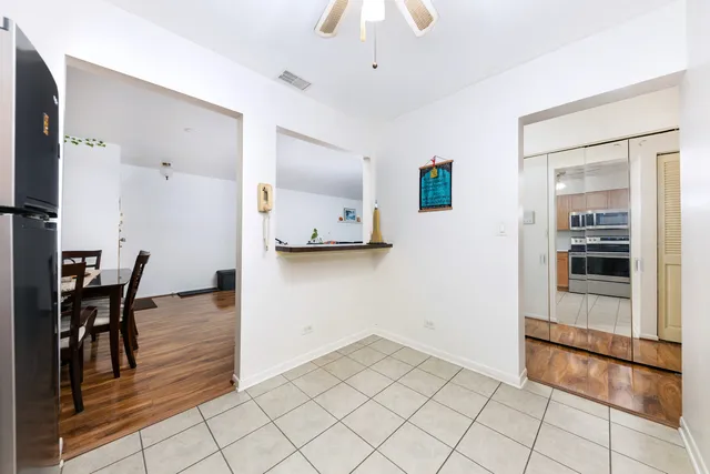 a view of a kitchen and an empty room