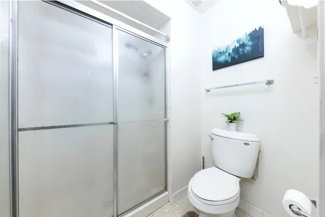 a white toilet sitting next to a bathroom sink