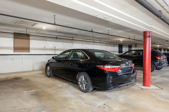 a view of parking garage with cars parked