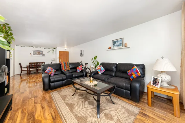 a living room with furniture and a wooden floor