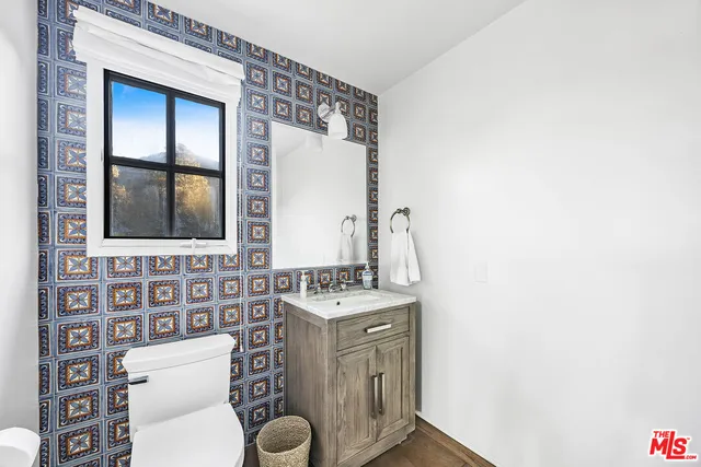 a bathroom with a toilet a sink and a mirror