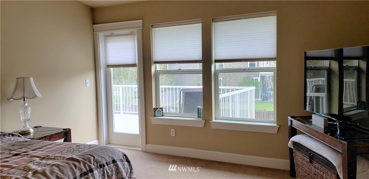 17834 Kenworth Lane Southwest Rochester, WA 98579 - Photo 15 of 29 a bedroom with a bed and a flat tv screen next to a window