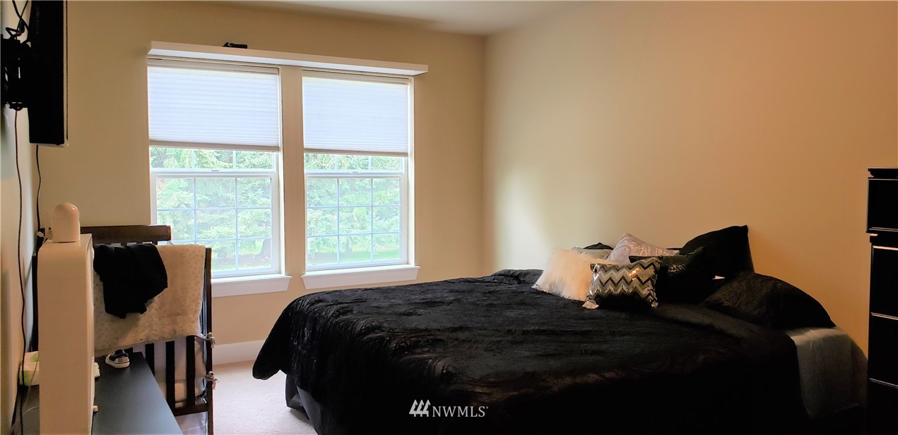 17834 Kenworth Lane Southwest Rochester, WA 98579 - Photo 18 of 29 a bedroom with a bed and wooden floor