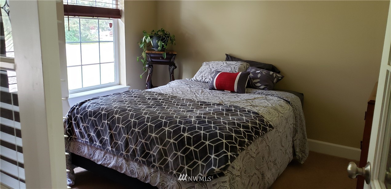 17834 Kenworth Lane Southwest Rochester, WA 98579 - Photo 23 of 29 a bed sitting in a bedroom next to a window