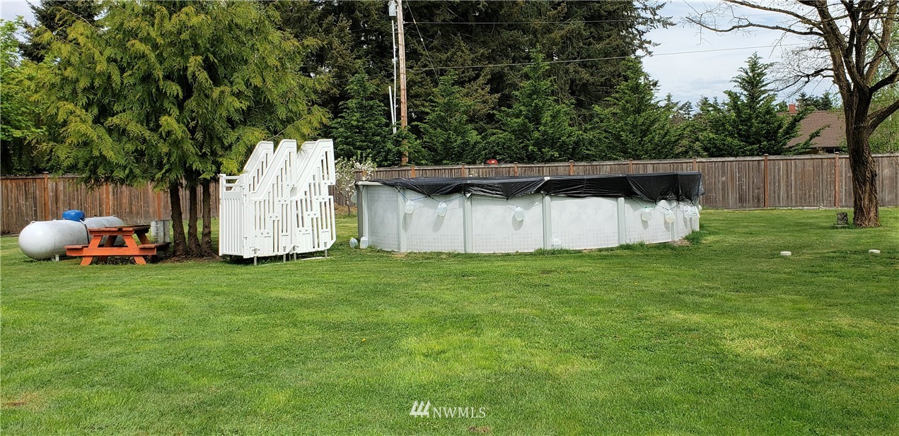 17834 Kenworth Lane Southwest Rochester, WA 98579 - Photo 5 of 29 a backyard of a house with lots of green space