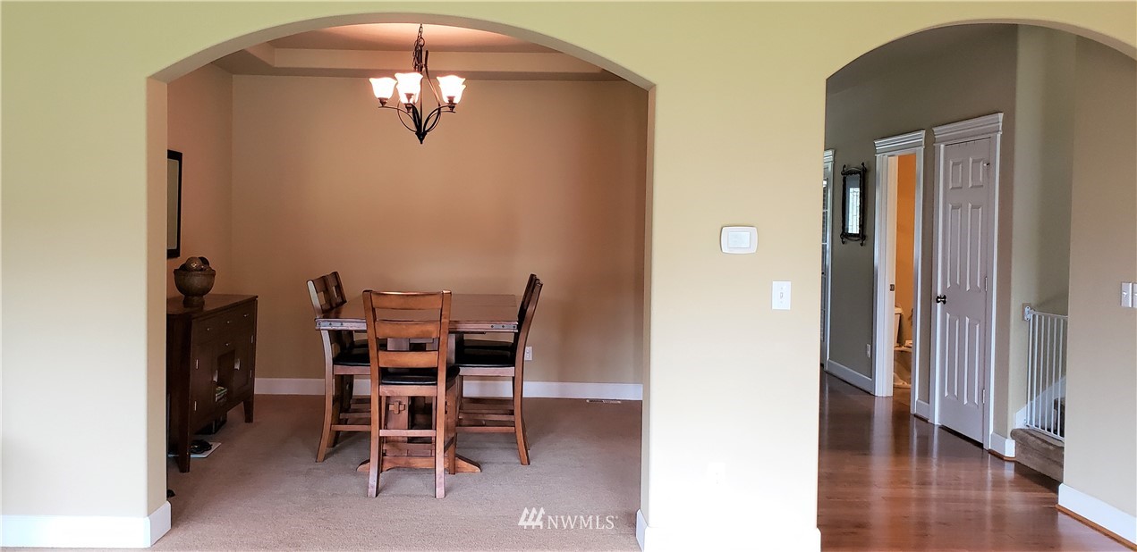 17834 Kenworth Lane Southwest Rochester, WA 98579 - Photo 7 of 29 a view of a dining room with furniture and wooden floor