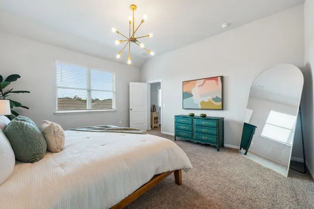 a bedroom with a bed and a television