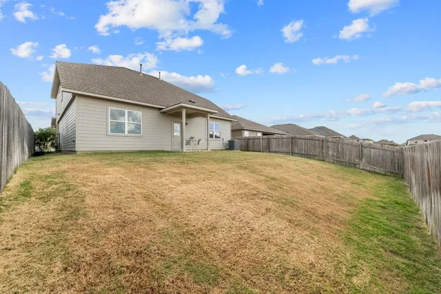 a view of a house with a backyard