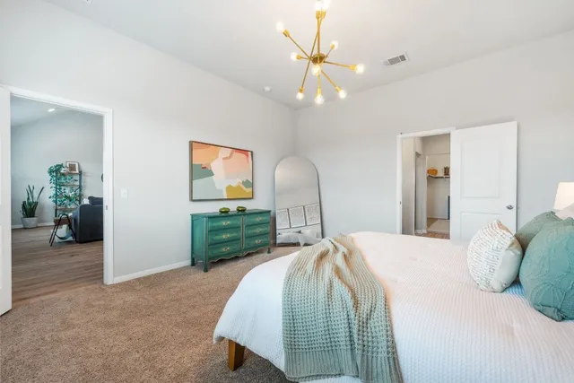 a bedroom with a bed and a mirror