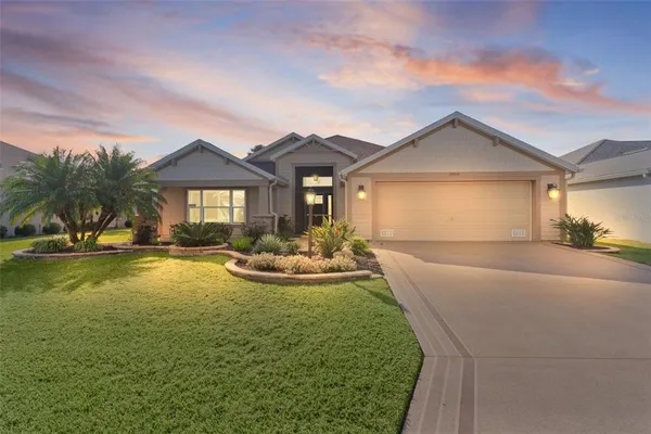 a front view of a house with swimming pool having outdoor seating