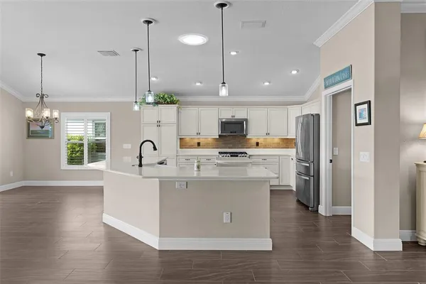 an aerial view of residential houses with outdoor space and lake view
