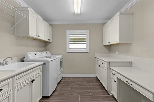 an aerial view of residential houses with swimming pool and outdoor space