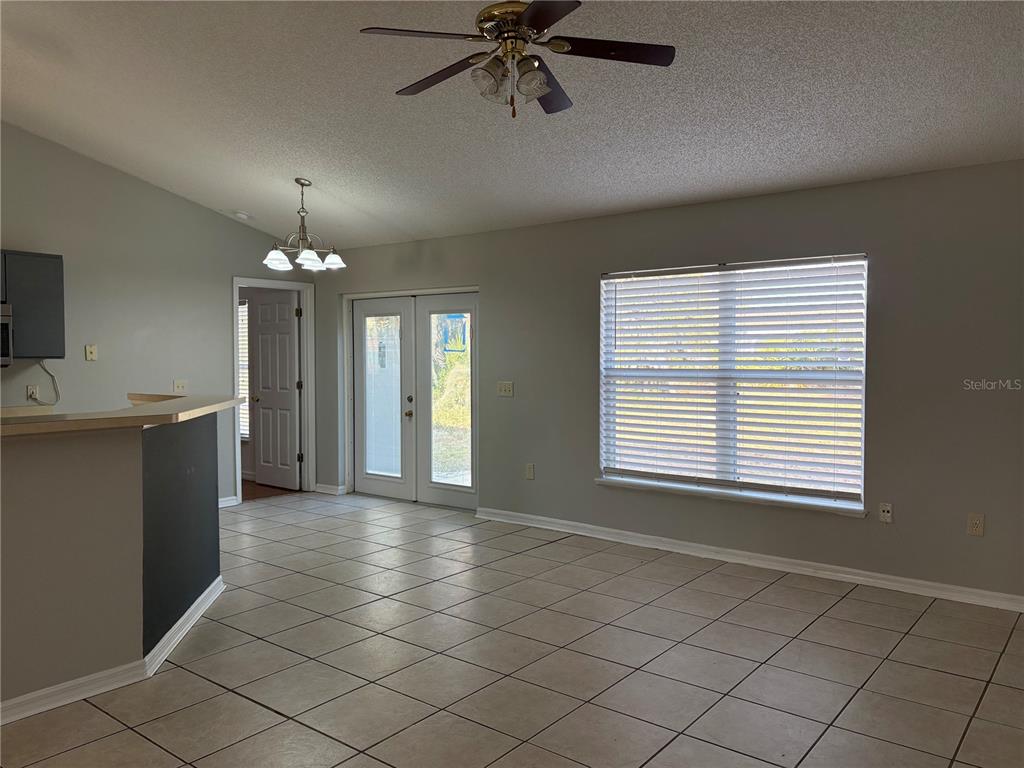 673 Eldron Avenue Deltona, FL 32738 - Photo 9 of 21 a view of a room and a kitchen